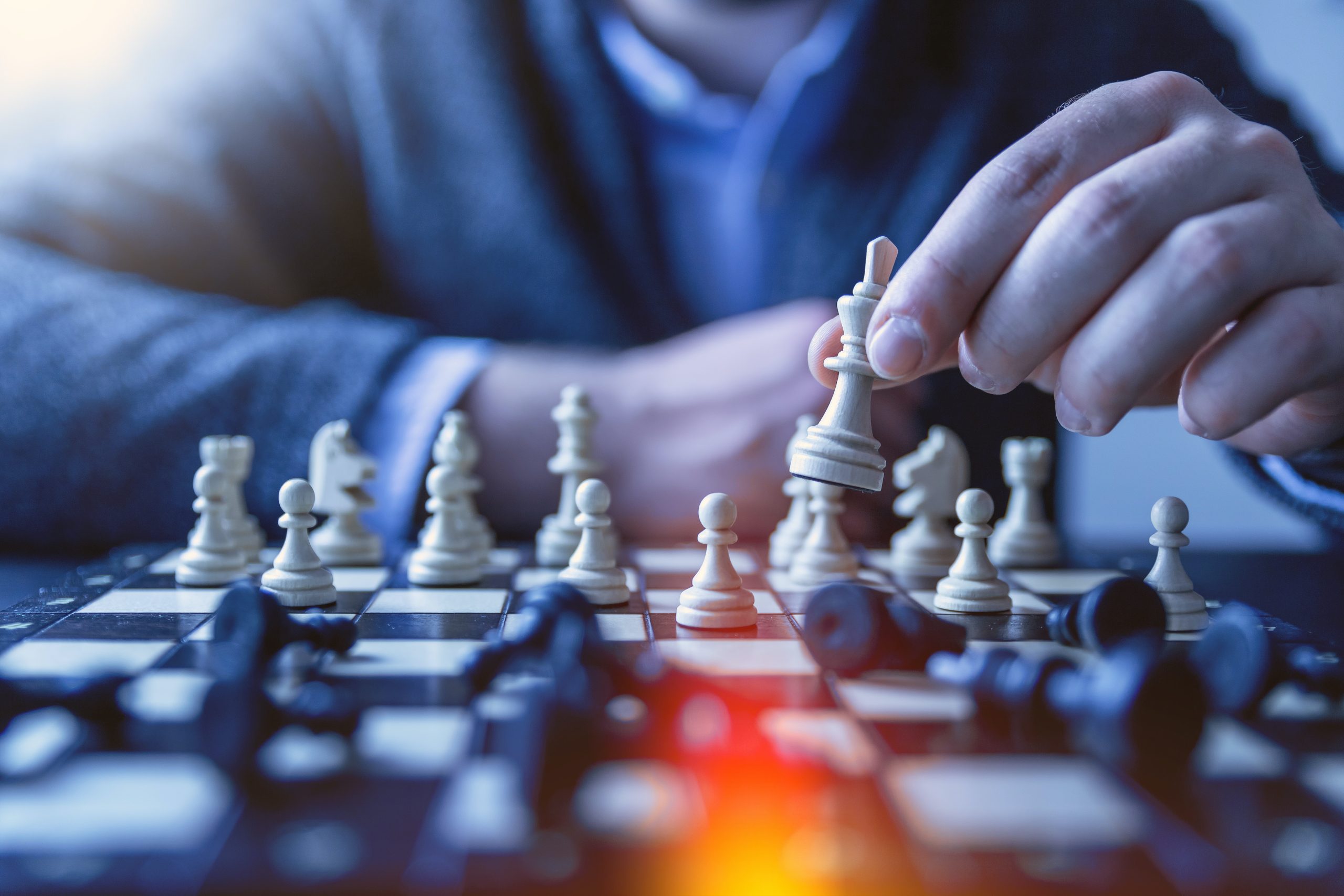 Man playing chess while considering life coaching.